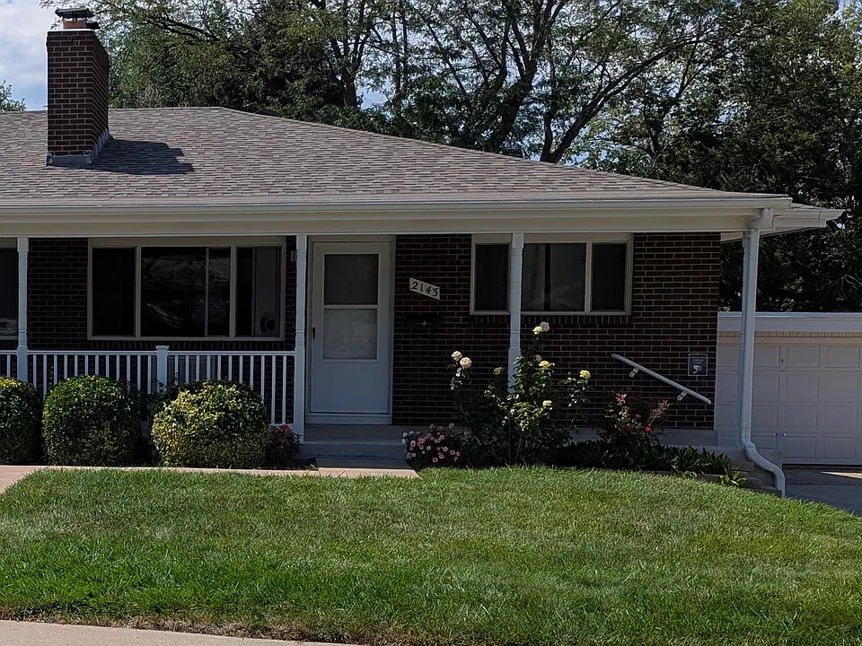 2143 19th Ave has a porch with nice flowers and shrubs.