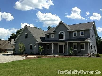 Front
						:
						View of the house with porch, patio, and front landscaping.