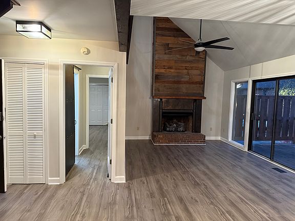 Family room with gas fireplace. Sliders to deck. Entrance to primary bedroom/bathroom.