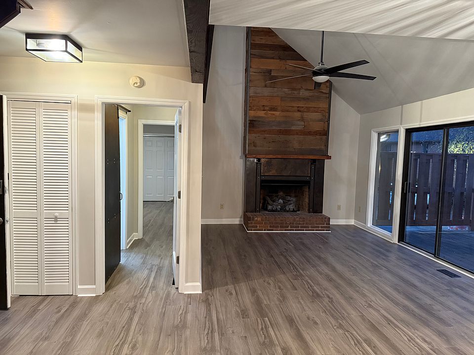 Family room with gas fireplace. Sliders to deck. Entrance to primary bedroom/bathroom.