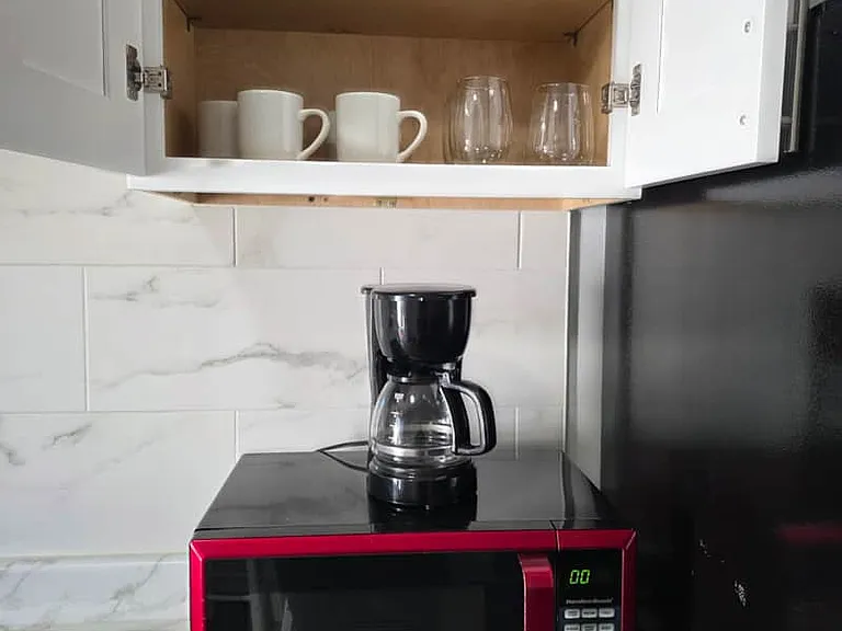 Includes coffee maker, microwave, glass cups, and mugs for your stay