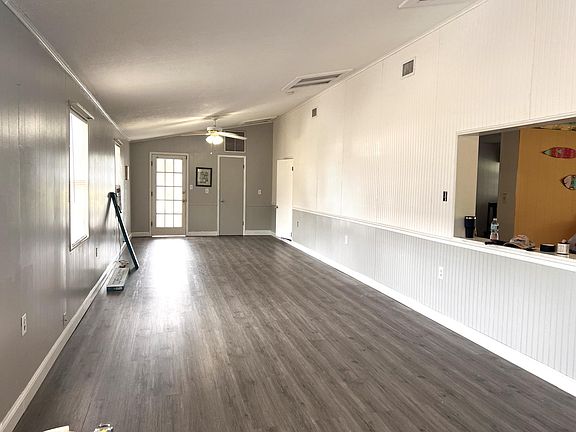 Large family / living room facing back door to screened porch