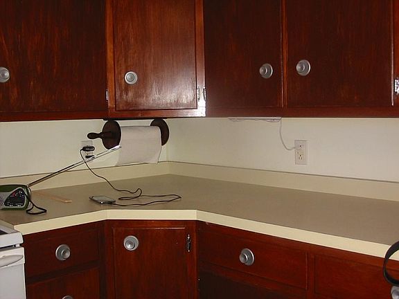 Kitchen counter next to the stove. All the cupboards have been thoroughly cleaned and lined.