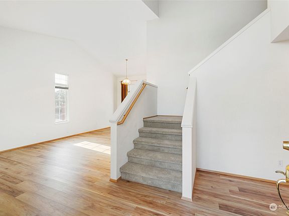 Enter into vaulted living space with all new LVP flooring throughout the downstairs>