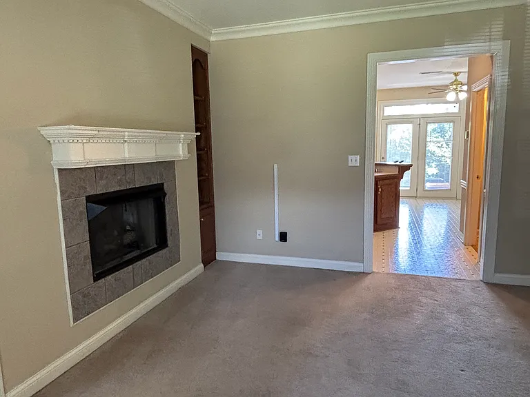 Living Room with gas logs and built-in bookshelves.