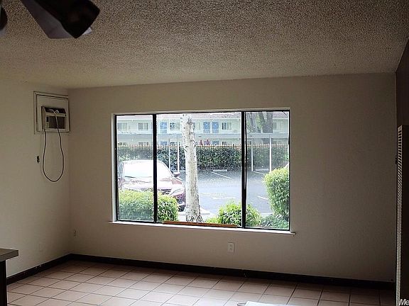 Living Room has Tile Flooring and overlooks the front parking lot and Laundry Room.
