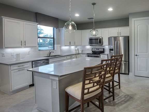 Model Representation Kitchen with center island, stainless appliances, 36 white cabinets