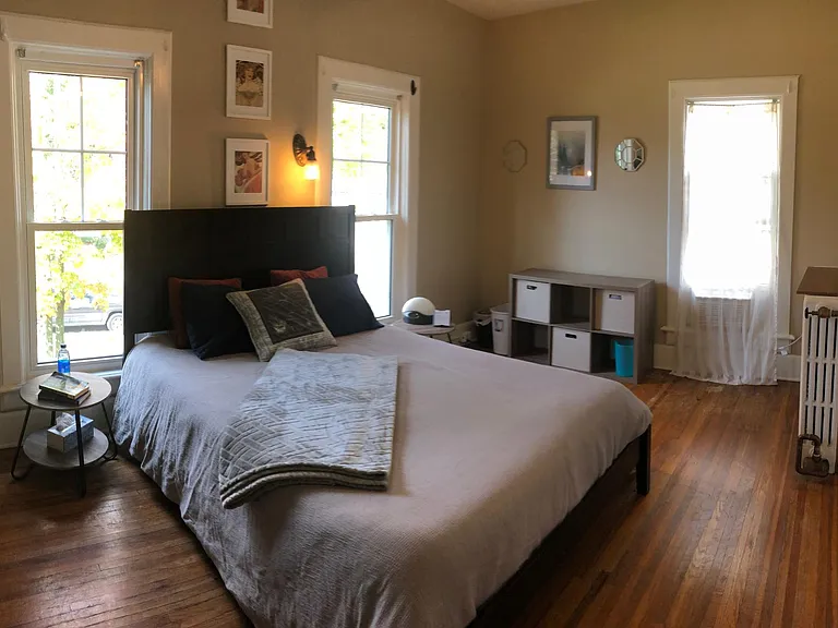 Main bedroom - hardwood floors, large windows, high ceilings, large closet.