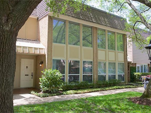 Two story townhouse/condominium with large windows providing plenty of natural light and abundant gu