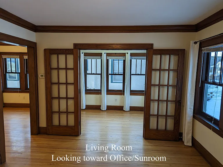 Living room looking west to sunroom/office with doors that can close