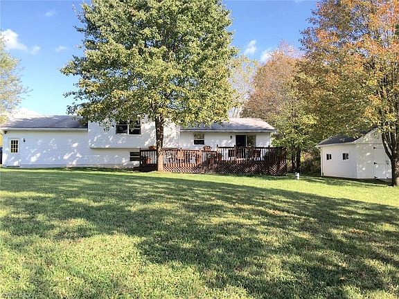 REAR OF HOME WITH TWO TIERED DECK AND STORAGE BARN