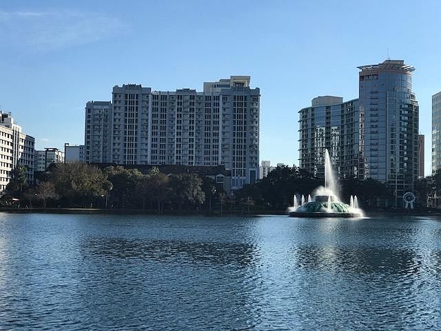 Beautiful Lake Eola with water fountain and Swan Paddle Boats