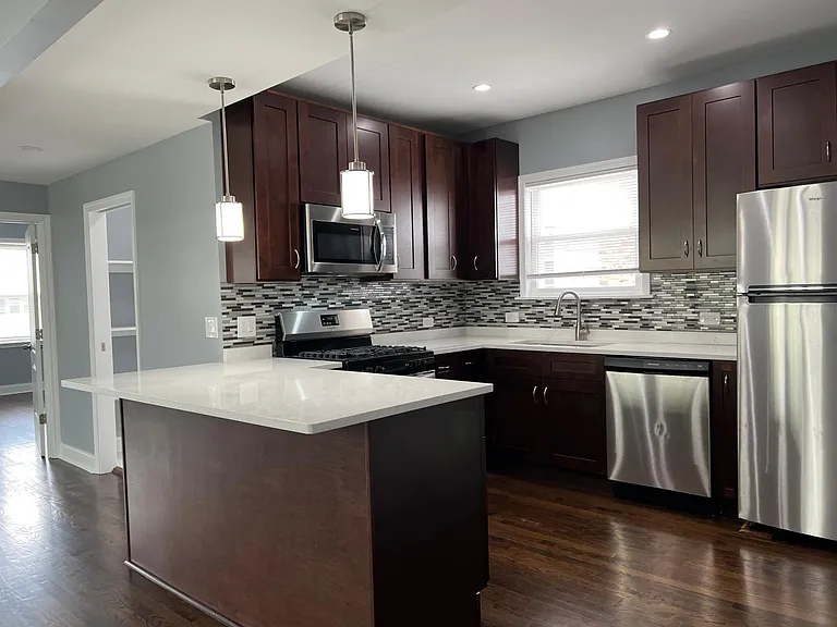 Newly renovated kitchen with 42" express cabinets, brand new stainless steel appliances (including dishwasher), quartz countertops with breakfast bar, and soft-close drawers!