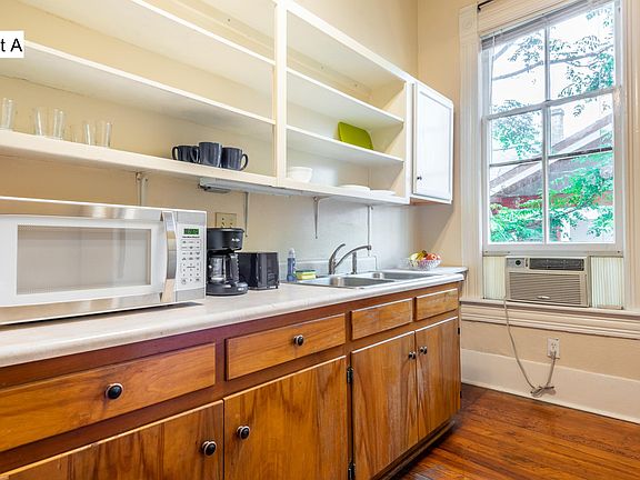 Kitchen with microwave, toaster, coffee maker and cooking basics supplies