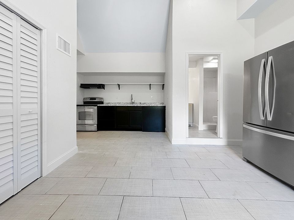 Open concept kitchen / living / dining space.