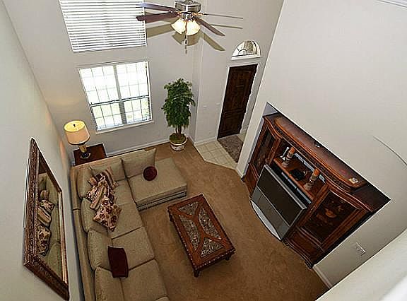 Family room with high ceiling and fan.