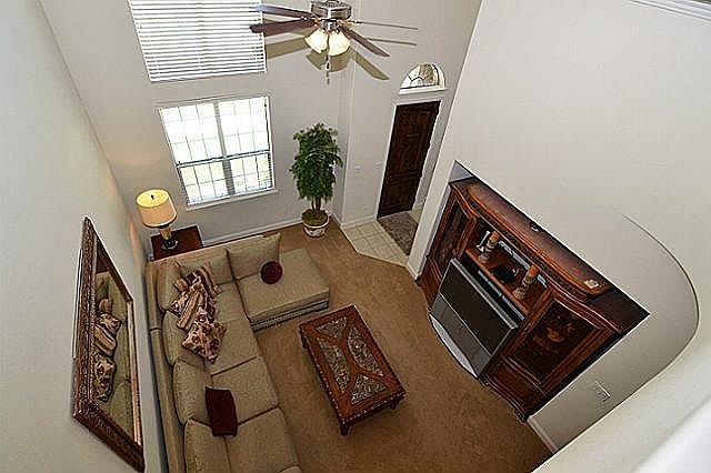 Family room with high ceiling and fan.