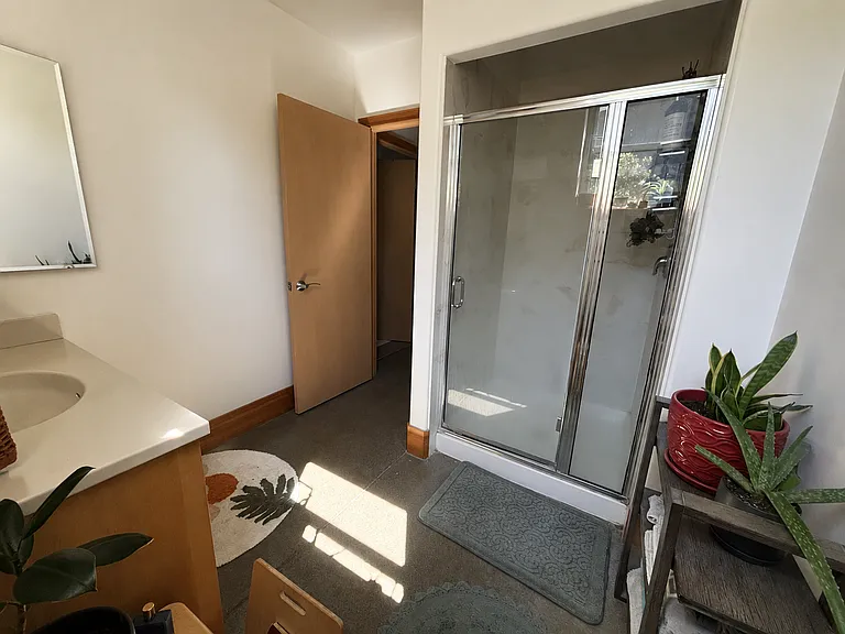 Large downstairs bathroom with roomy walk-in shower and plenty of natural light.