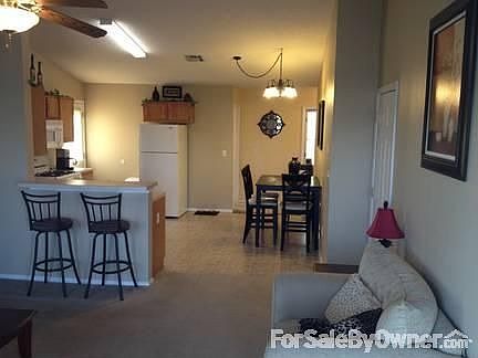 Living Room and Kitchen : updated lighting; high celings; display space over cabinets; appliances re