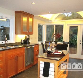 Deluxe gourmet kitchen with marble pub table and french door