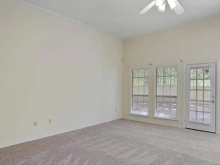 Windows in family room, ceiling fan, new carpet. Covered patio view