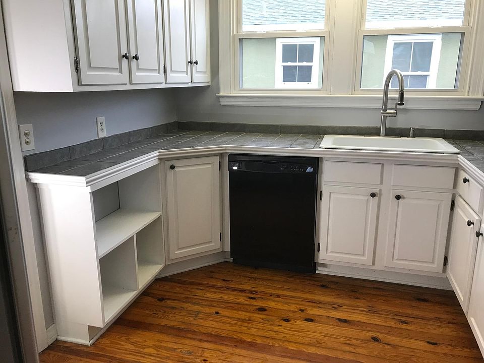 kitchen with lots of storage and large whirlpool refrigerator with ice and ceiling Fan