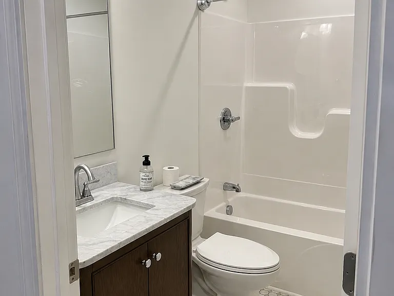 All new chrome fixtures, new toilet, marble vanity, tiled flooring and all new pex plumbing.