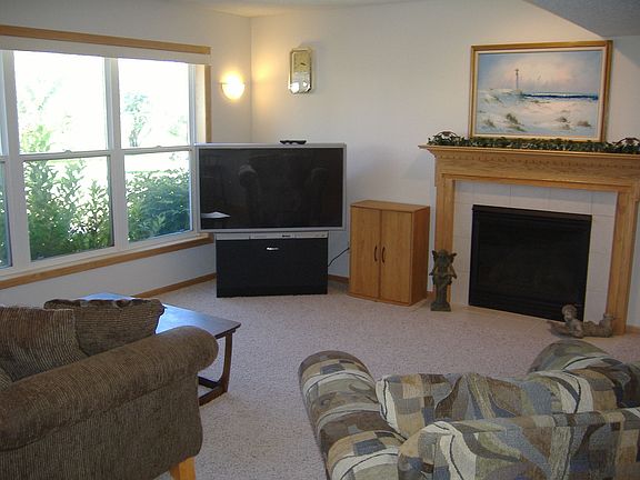 Finished lower level features a second fireplace, built-in bar, gaming areas, 