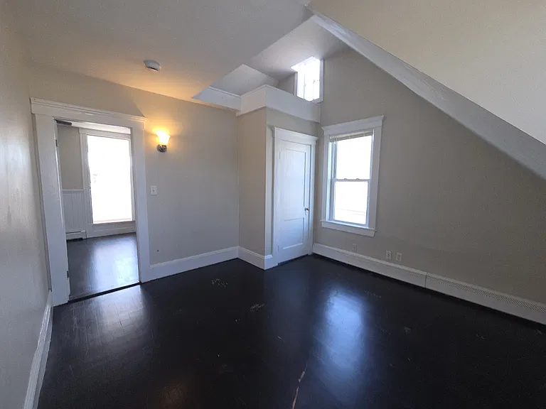 bedroom off kitchen, vaulted ceilings, closet and storage space two windows