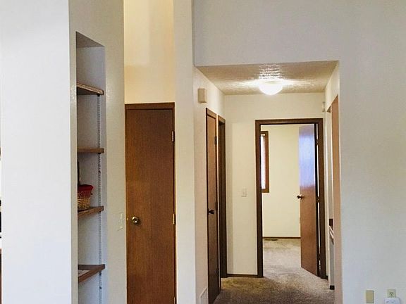 Vaulted ceilings with view down hallway.