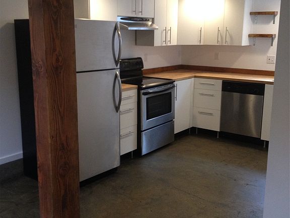 Ikea kitchen with stainless steel refrigerator, dishwasher,