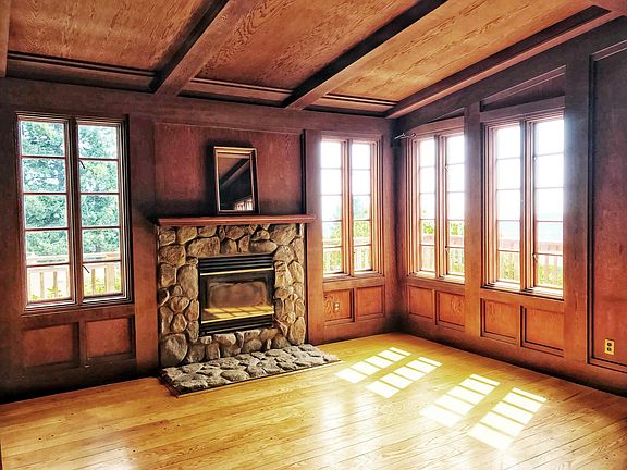 Wood burning stone fireplace is centerpiece of panelled Mayb