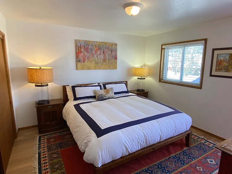 Master bedroom with king mattress and door to front deck.