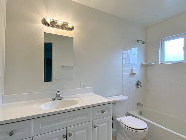 Bath; Photos of a similar unit. Available unit has luxury vinyl "wood" plank flooring throughout except in the bedroom (high grade Berber carpet).