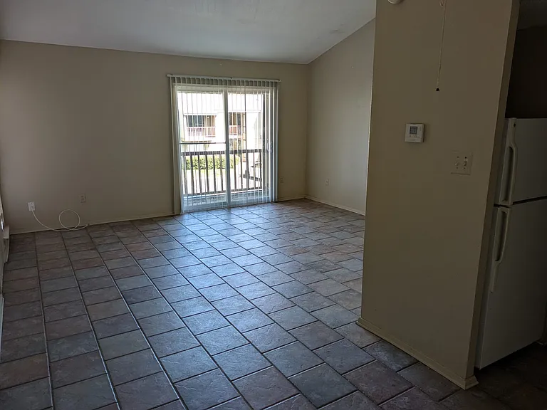 View of the living area from the dining area and facing the balcony porch.