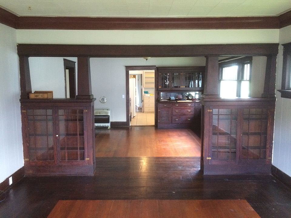 This Craftsman bungalow features beautiful old-growth fir built-ins that showcase its original 1920s charm. In the dining room, a classic built-in china cabinet offers both display space and storage. Knee walls with glass doors in living room.