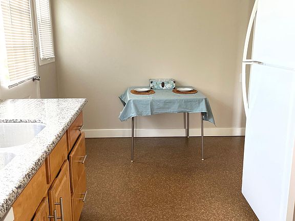 Long kitchen includes generous eat-in area.