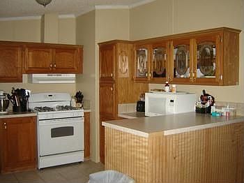 br /A great sized Kitchen!  Super cupboard space and counter.br /Eating bar also.br /Glass cupboard doors to diplay your favorite, special dishes.