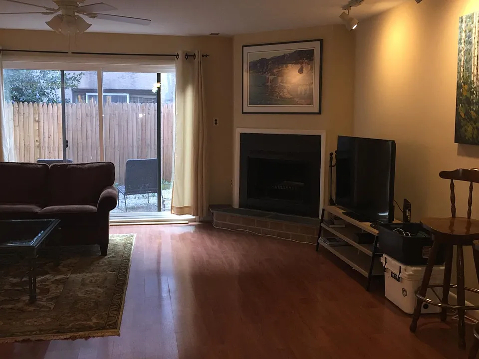 Open Plan Downstairs with Fireplace and Sliders to Patio