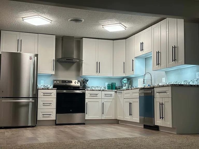 Newly remodeled Kitchen - Granite countertops, stainless range hood, GE Appliances, and undercounter lighting.