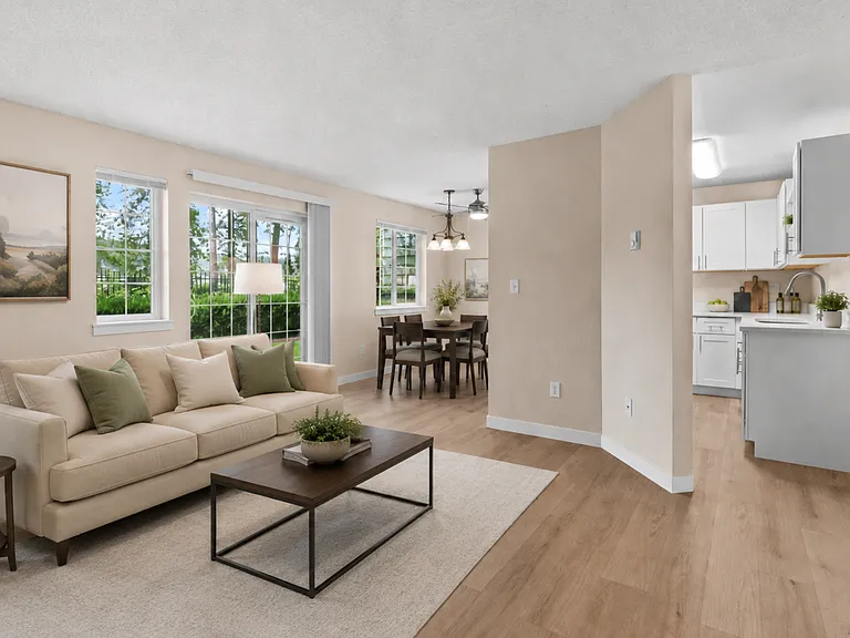 A bright, open living and dining space with abundant natural light, direct patio access, and a comfortable layout for relaxing or entertaining. A bright, open living and dining space with abundant natural light, direct patio access, and a comfortable layo