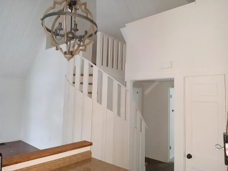 Looking from kitchen up to loft. Bathroom and bedroom are to the right and left (behind) the staircase