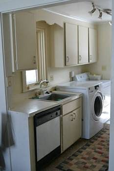 The kitchen is a galley style.  Very compact with the washer and dryer located in the same area by the rear entrance.  The appliances will be staying with the home.