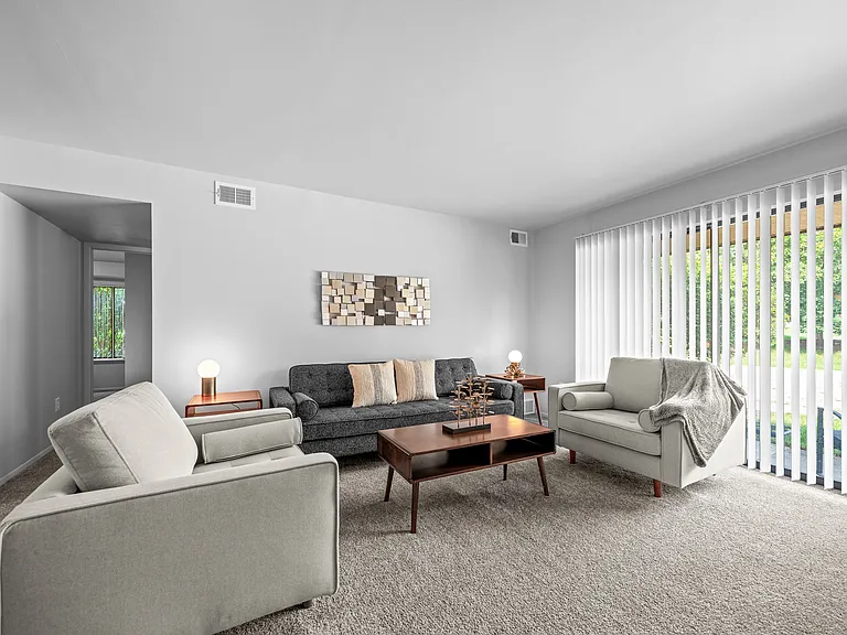 Living room with patio at Dover Hills Apartments in Kalamazoo