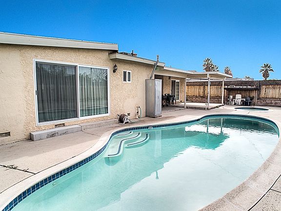 The private backyard with a sparkling pool and spa
