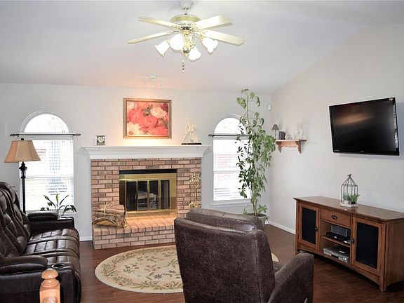 Vaulted great room with wood burning fireplace and the NEW hand-scraped wood floor.