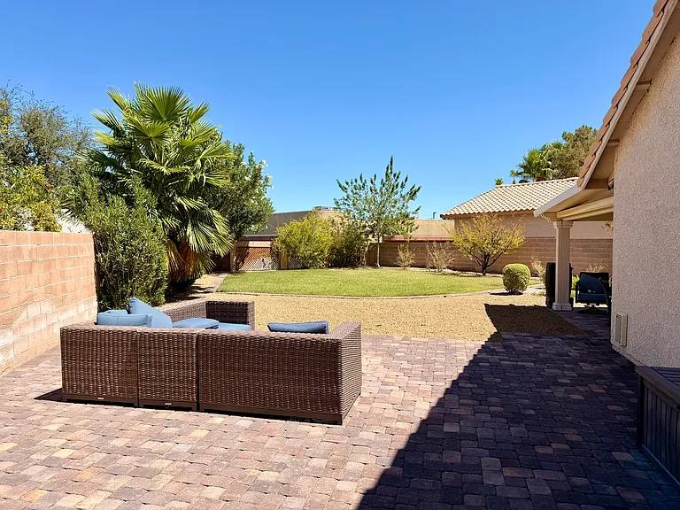 Side patio looking into backyard. Pet door on right side.