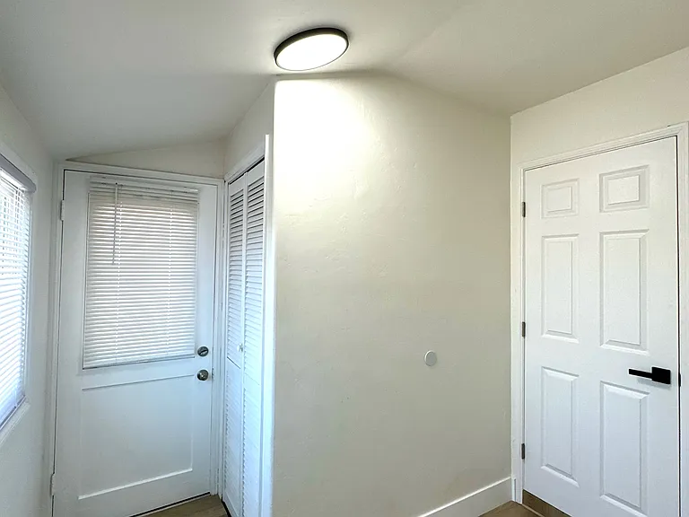Small bonus room with additional closet/storage space and second entry/exit door.