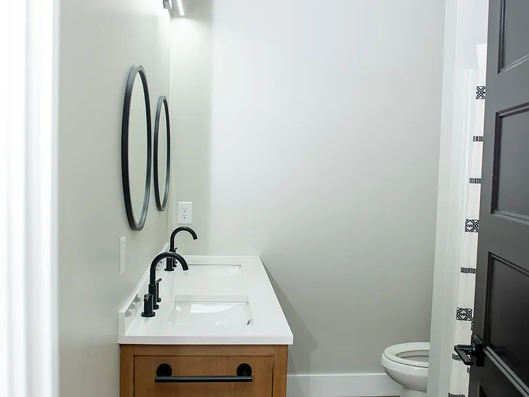 Primary bathroom - double vanity, bathtub and toilet