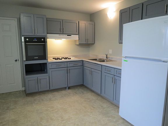 kitchen-new luxury vinyl plank being installed; this shows the old floor